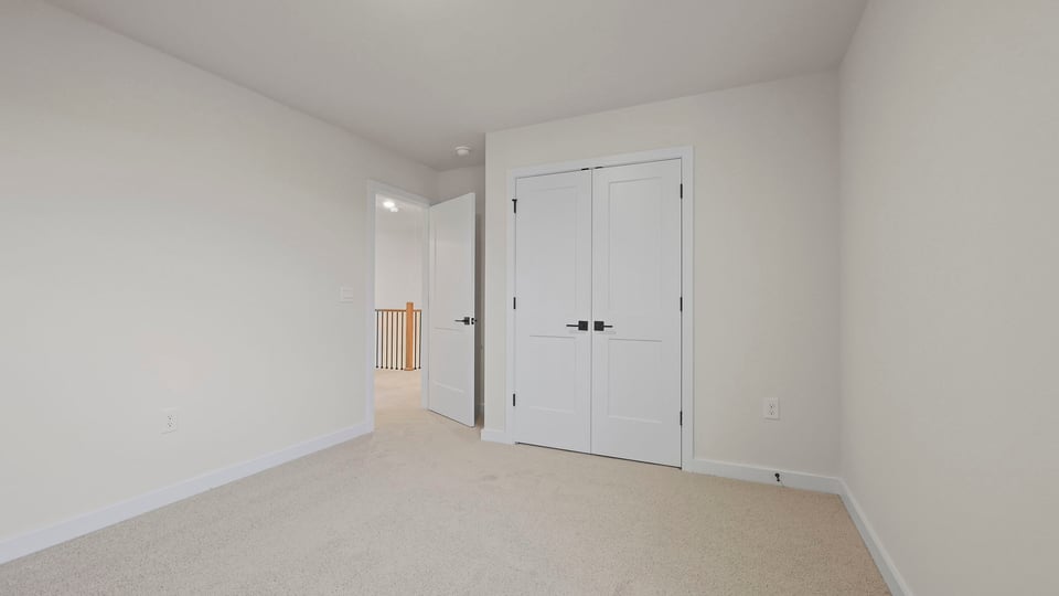Bedroom with carpet and windows.