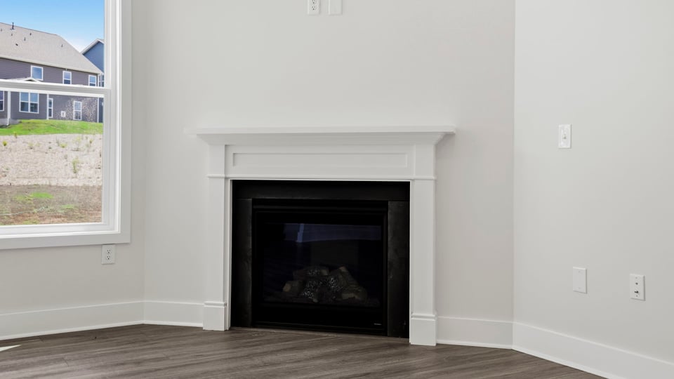 Living area with windows and fireplace.