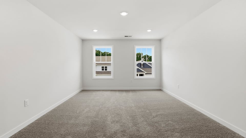 Loft with carpet and windows.