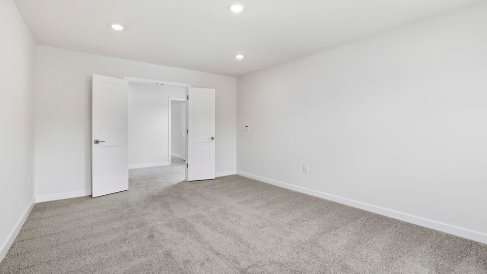 Loft with carpet and windows.