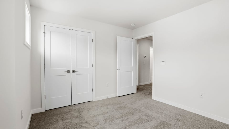 Bedroom with window and closet.