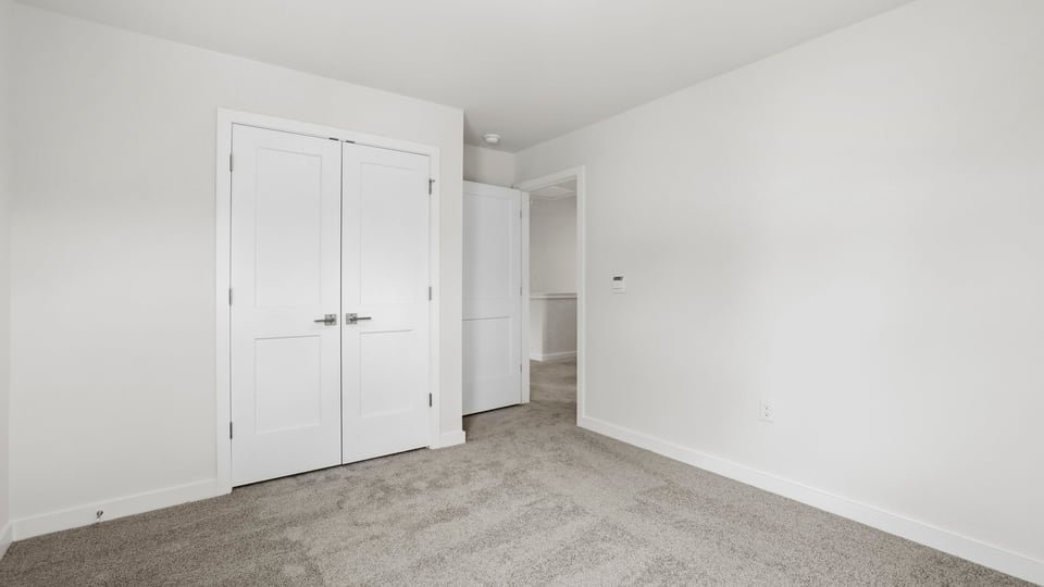 Bedroom with window and closet.
