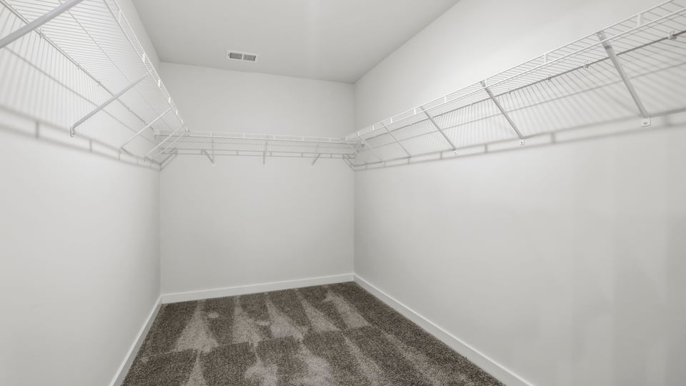 Primary closet with shelf.