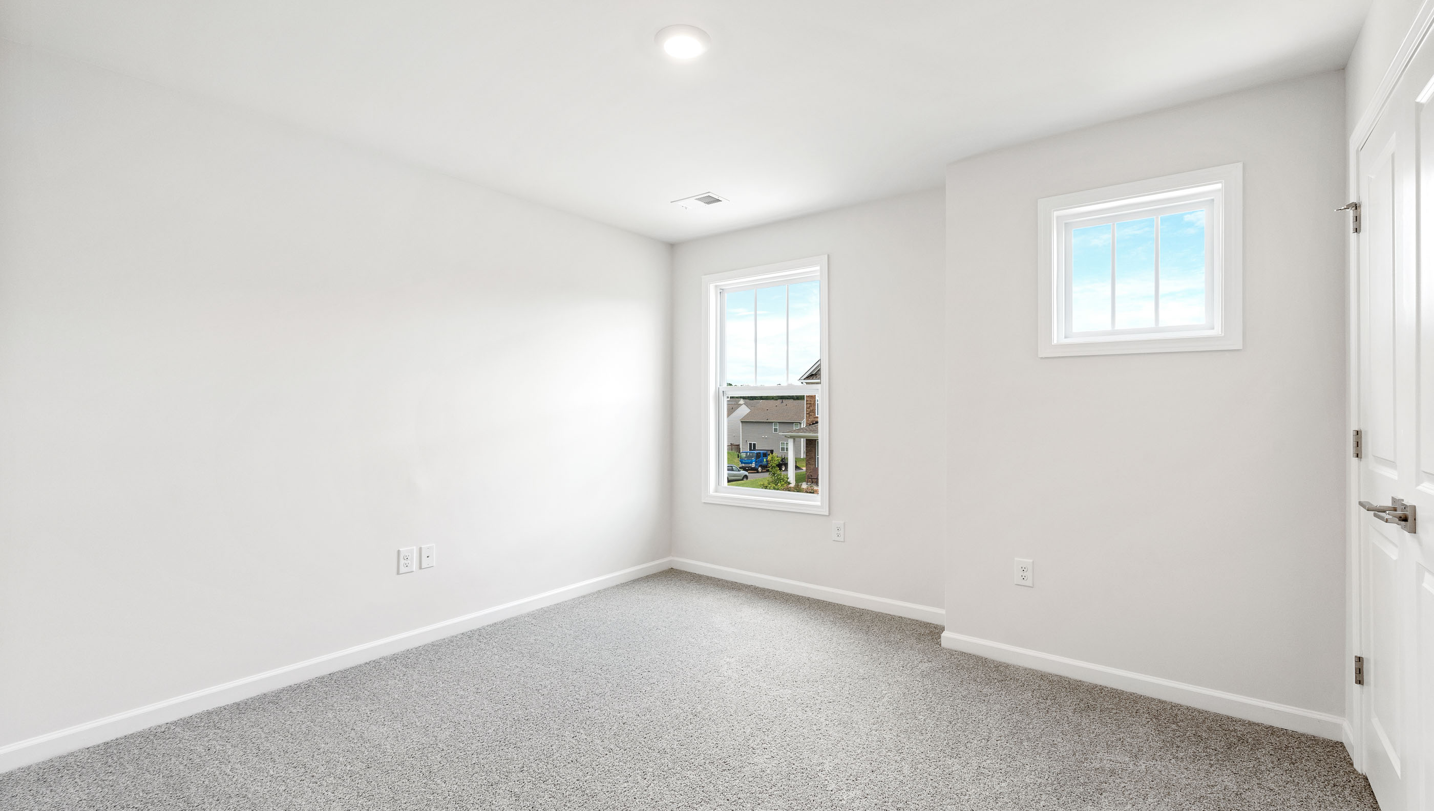 Bedroom with carpet and window.