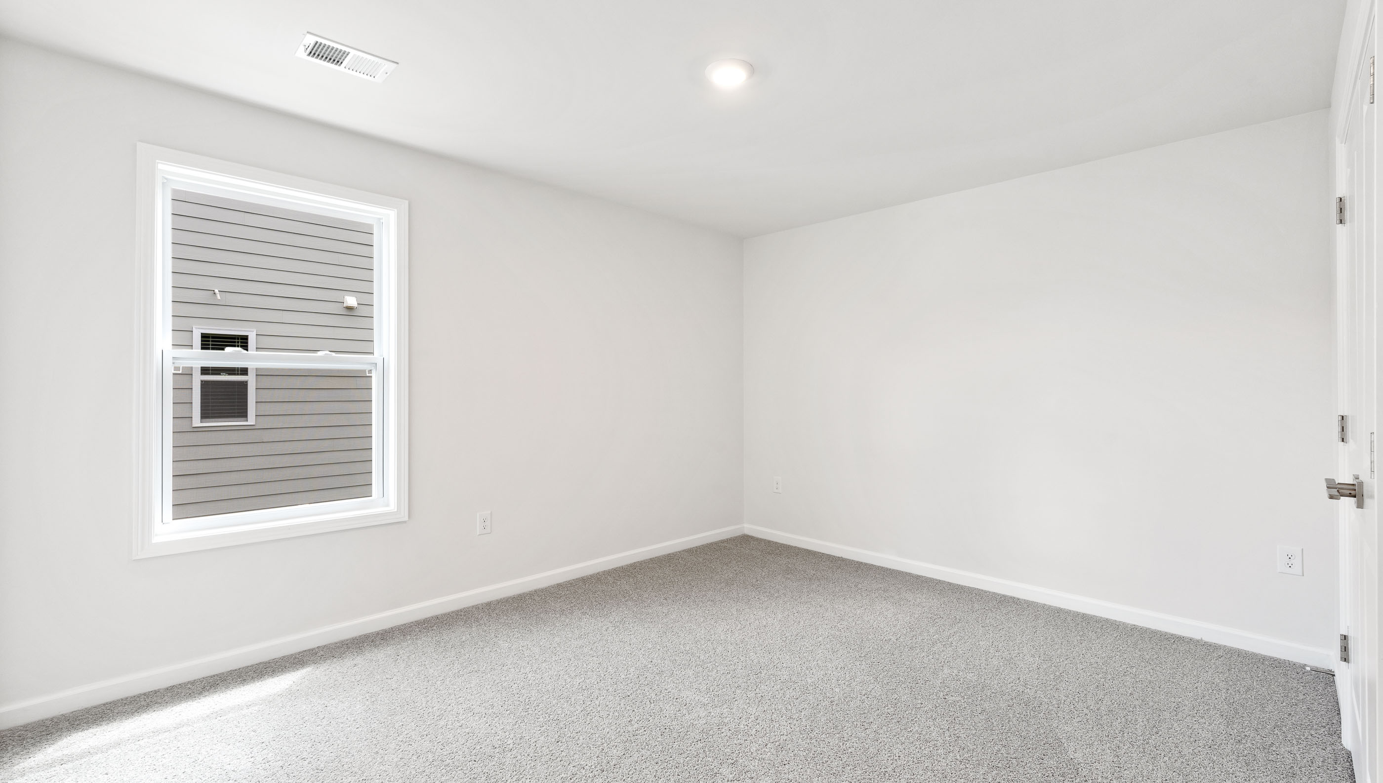 Bedroom with carpet and window.