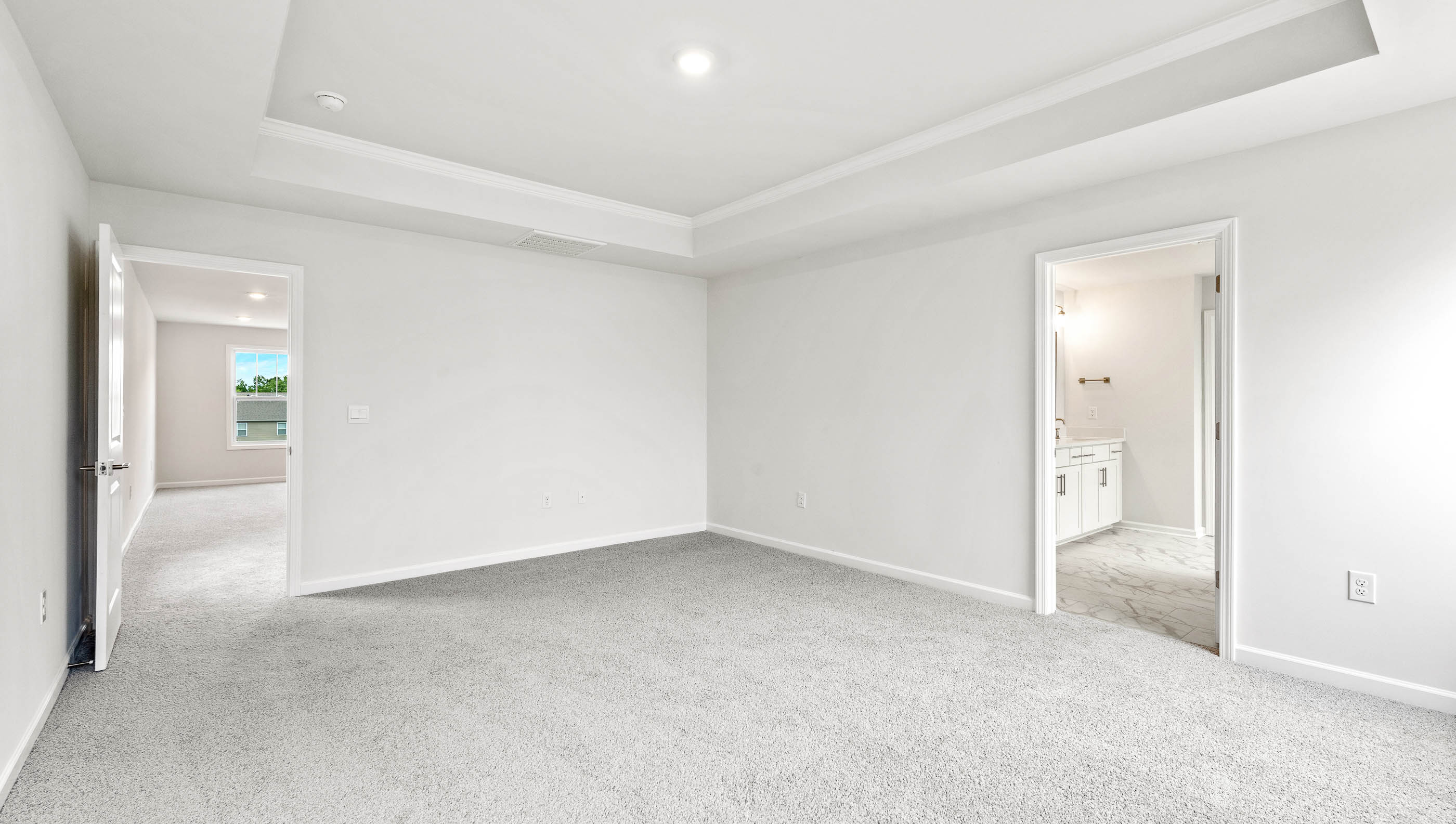 Bedroom with carpet and window.