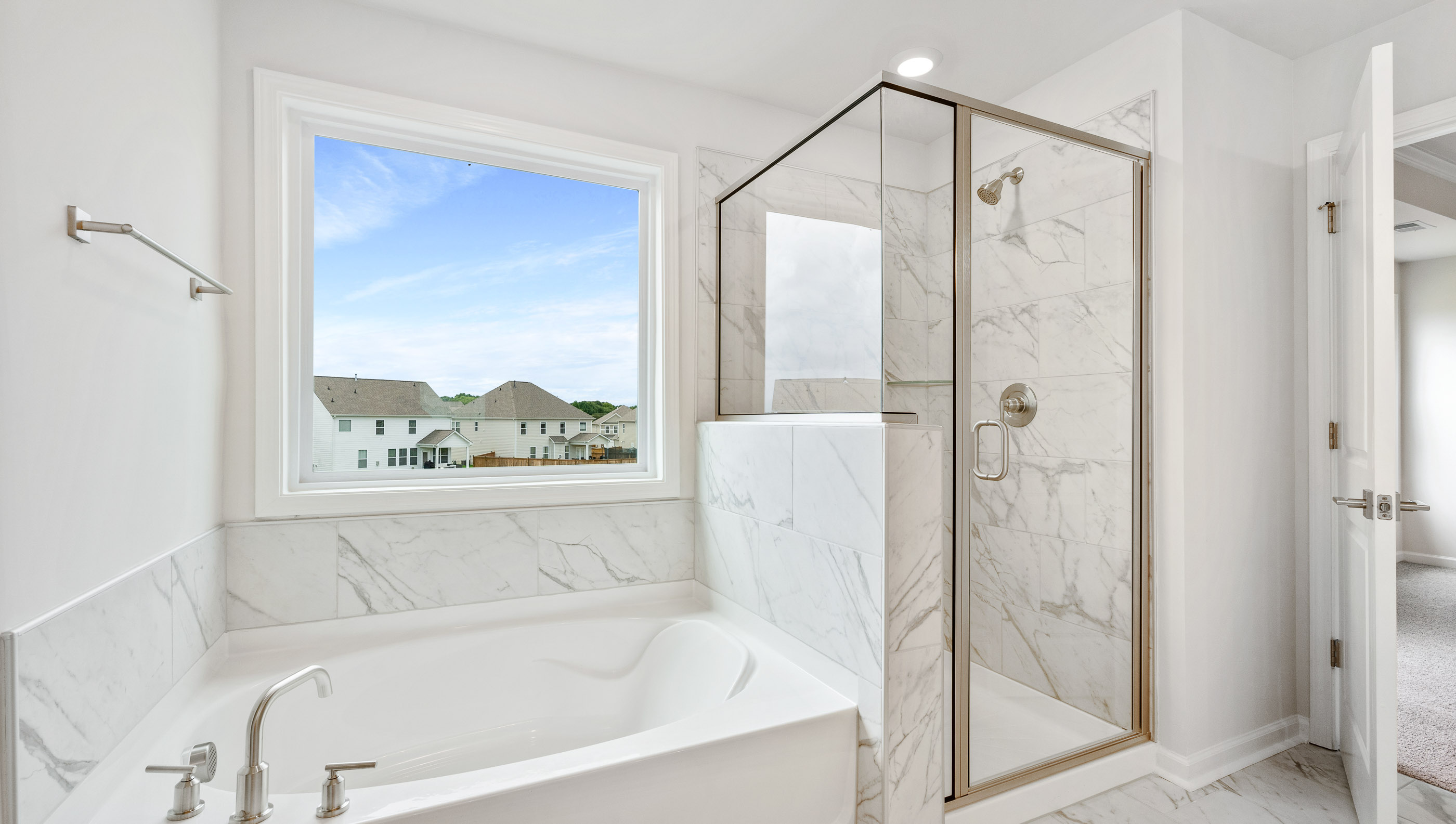 Bathroom with tub and walk in shower.