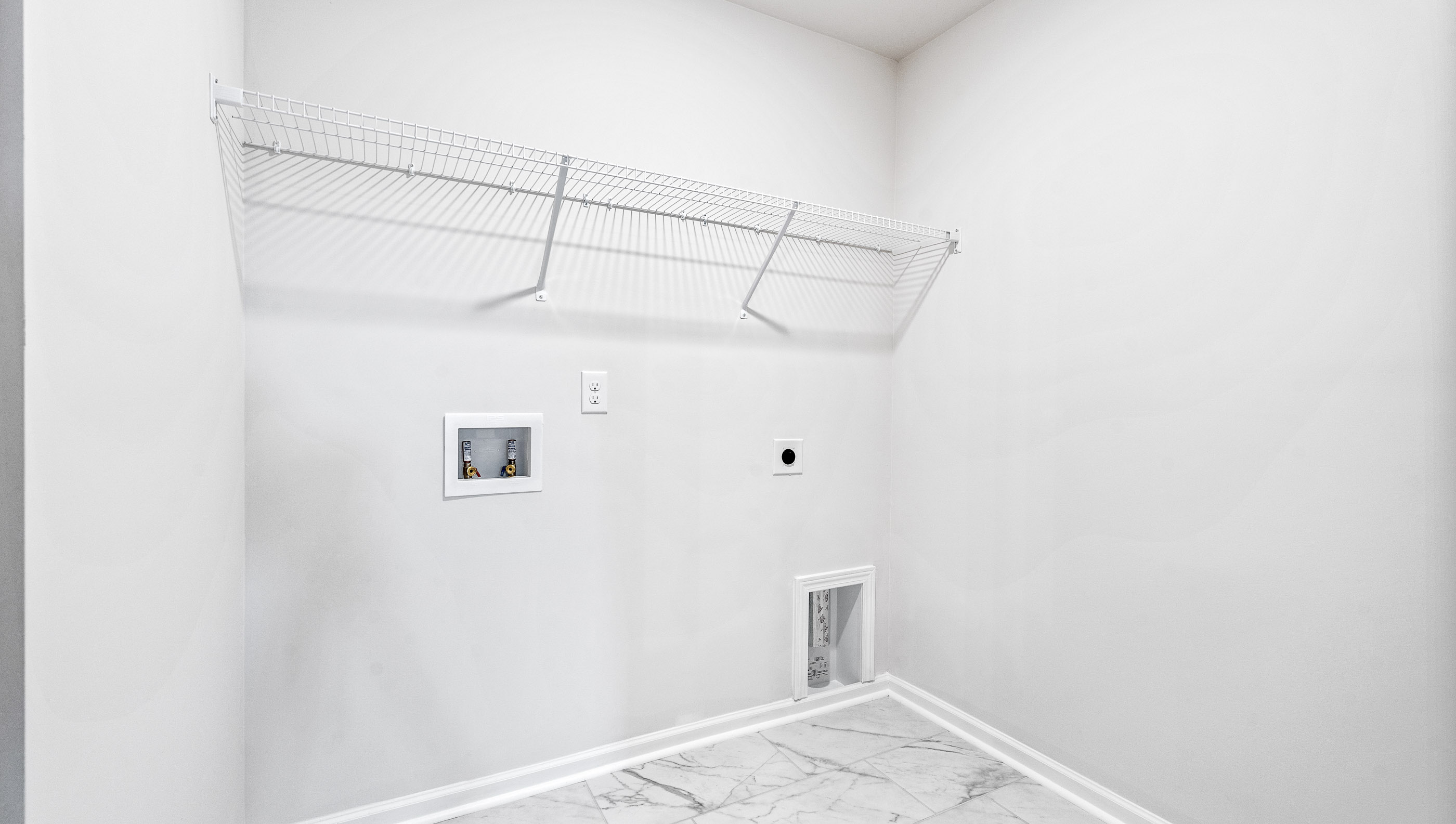 Laundry room with hanging storage racks.
