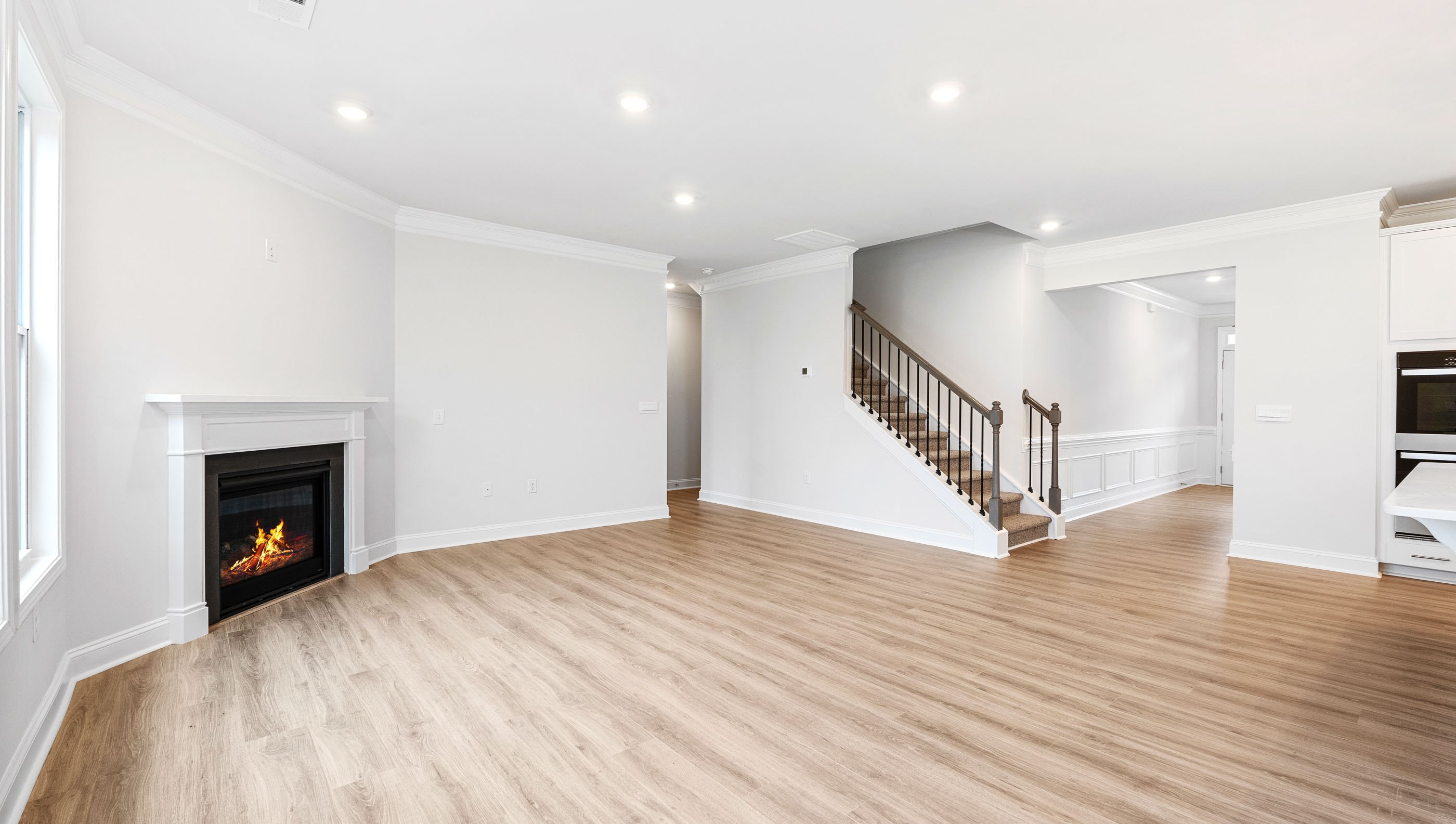 Family room with fireplace and stairs.