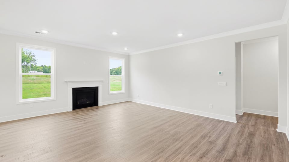 Living room with windows and fireplace.