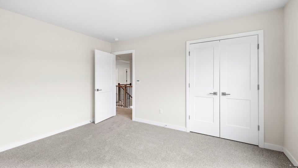 Bedroom with carpet and windows.