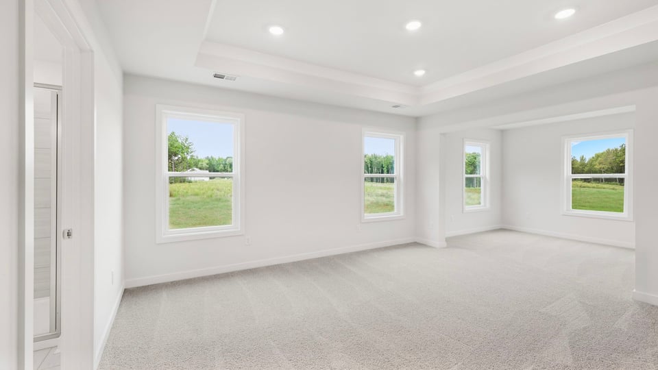Bedroom with carpet and windows.