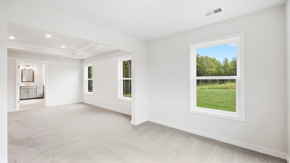 Bedroom with carpet and windows.