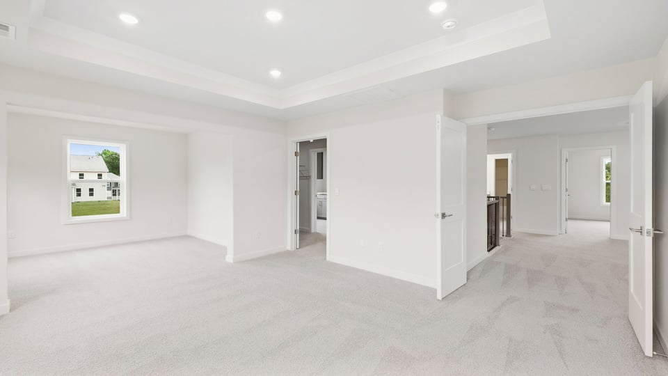 Bedroom with carpet and windows.