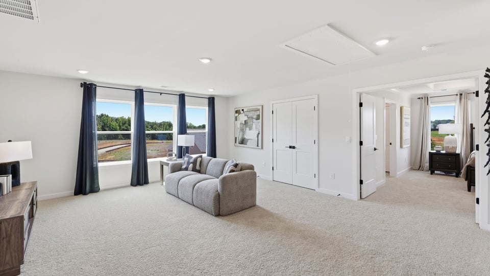 Loft with carpet and windows.