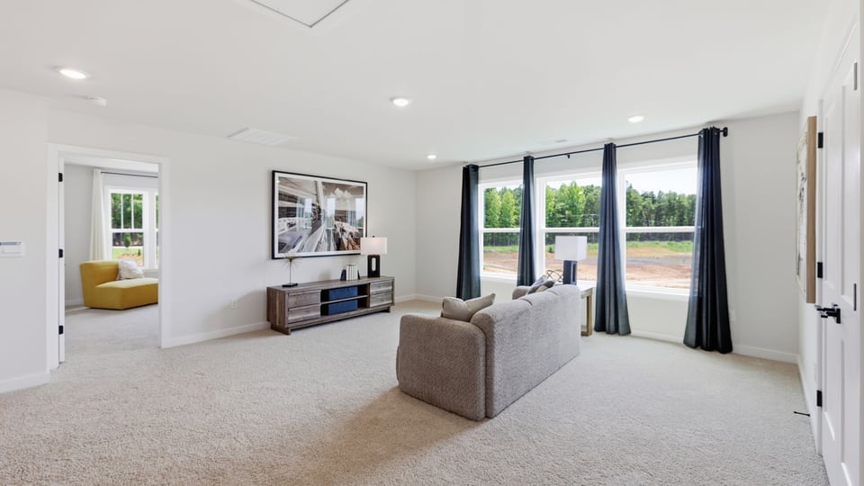 Loft with carpet and windows.