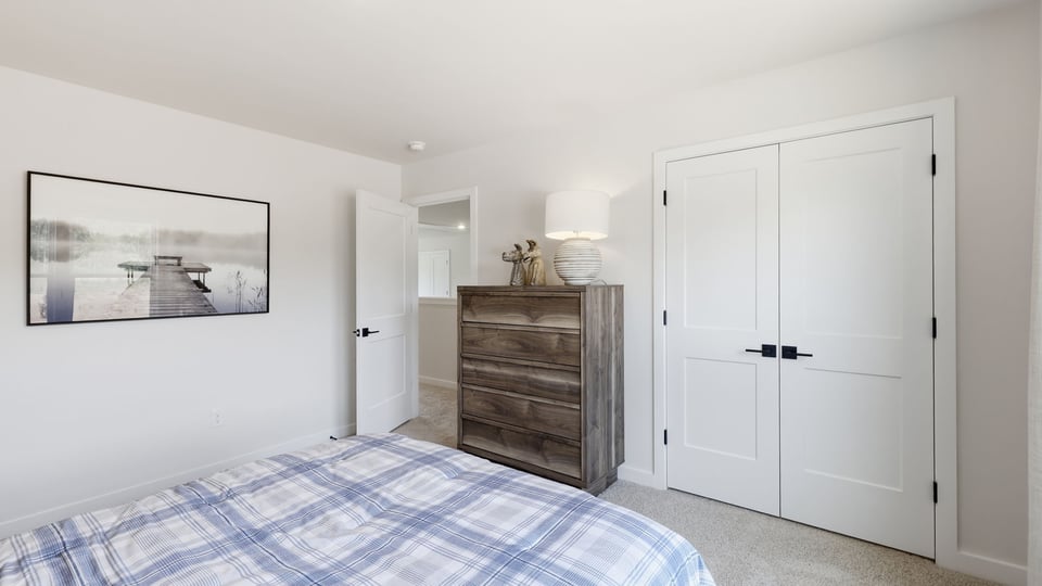 Bedroom with carpet and windows.
