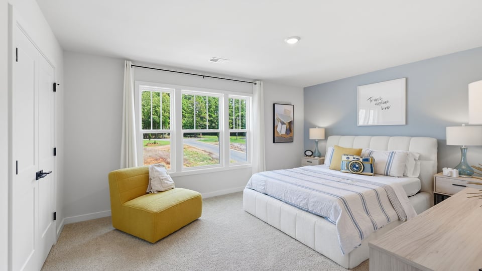 Bedroom with carpet and windows.