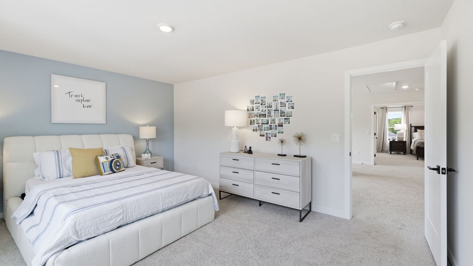 Bedroom with carpet and windows.