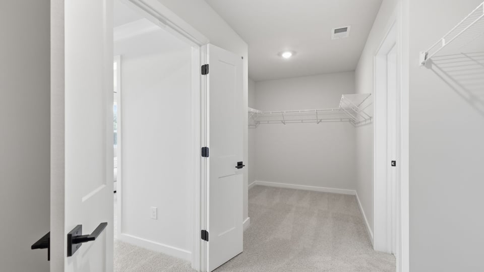 Primary closet with shelf.