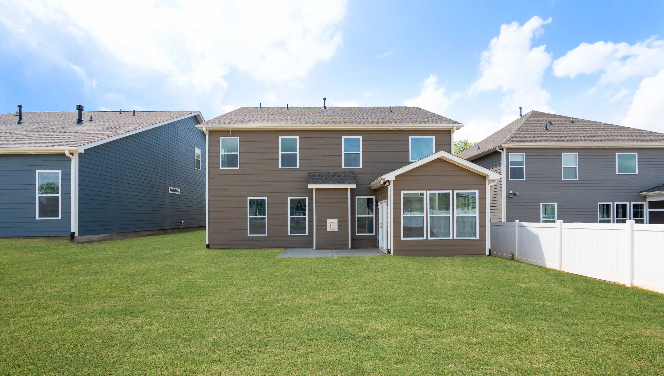 Back exterior of home with large backyard.