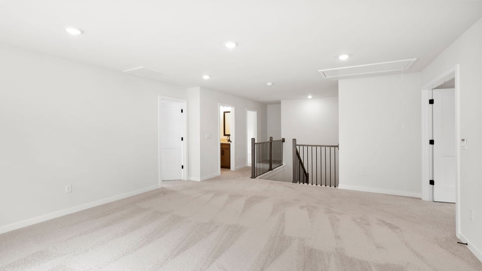 Bedroom with windows and carpet.