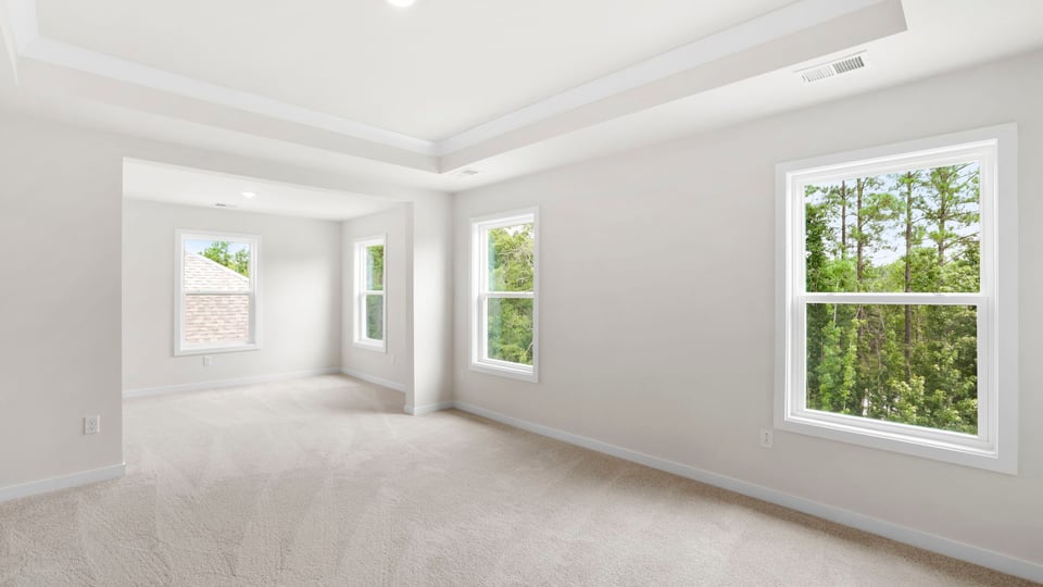 Bedroom with windows and carpet.