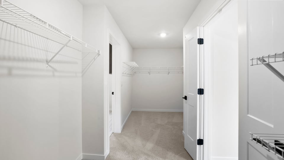 Primary closet with shelf.