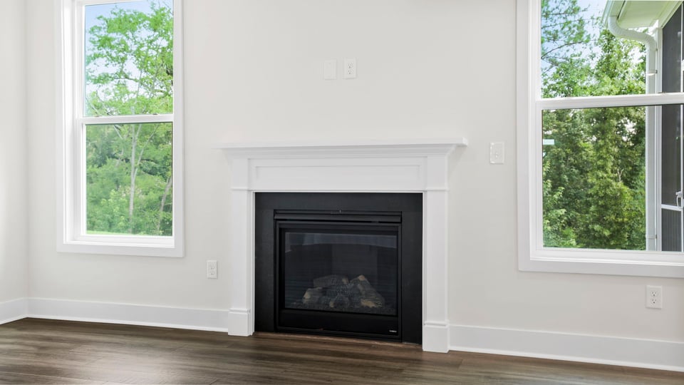 Living area with windows and fireplace.