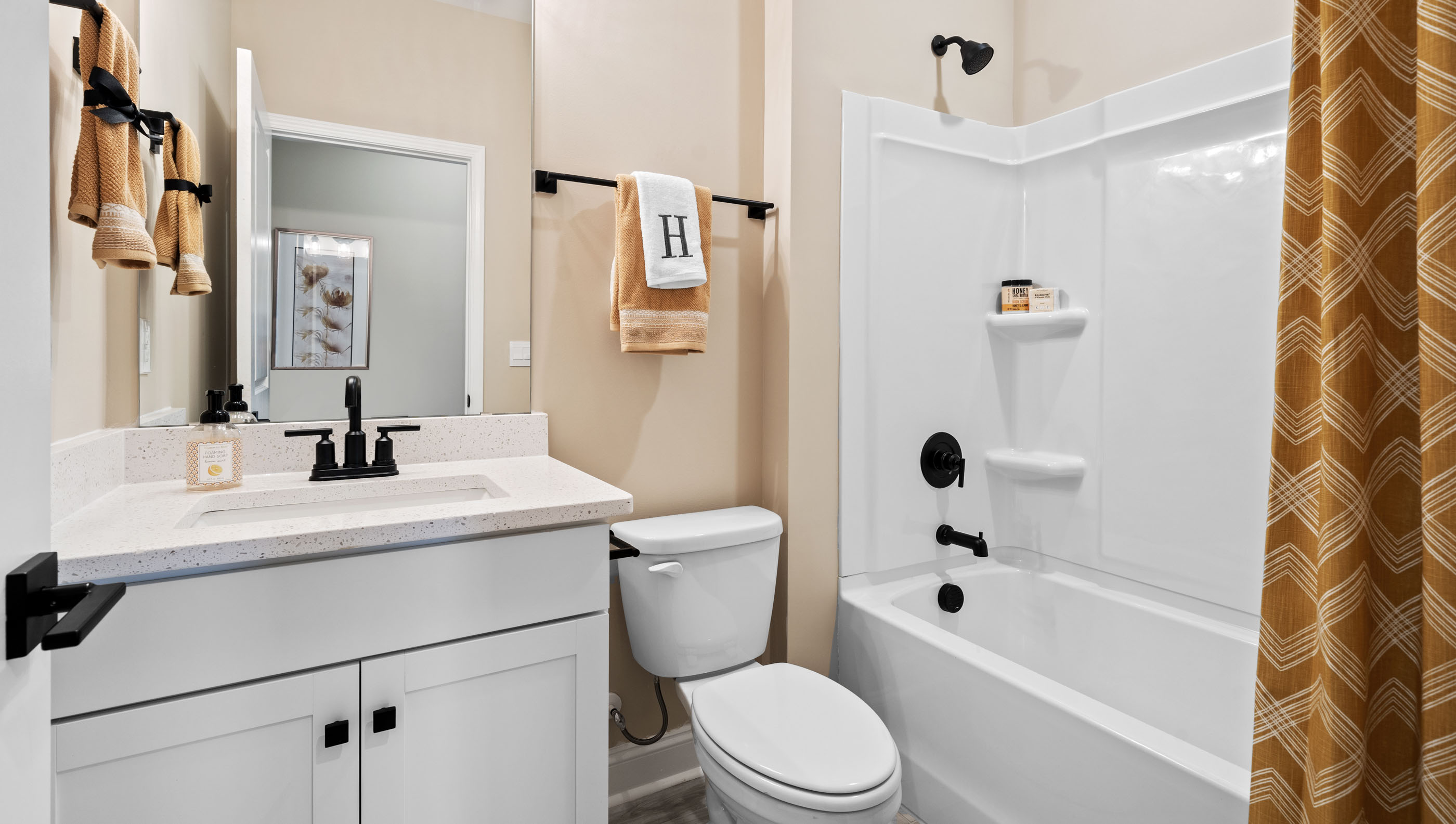 Bathroom with single vanity sink and tub.