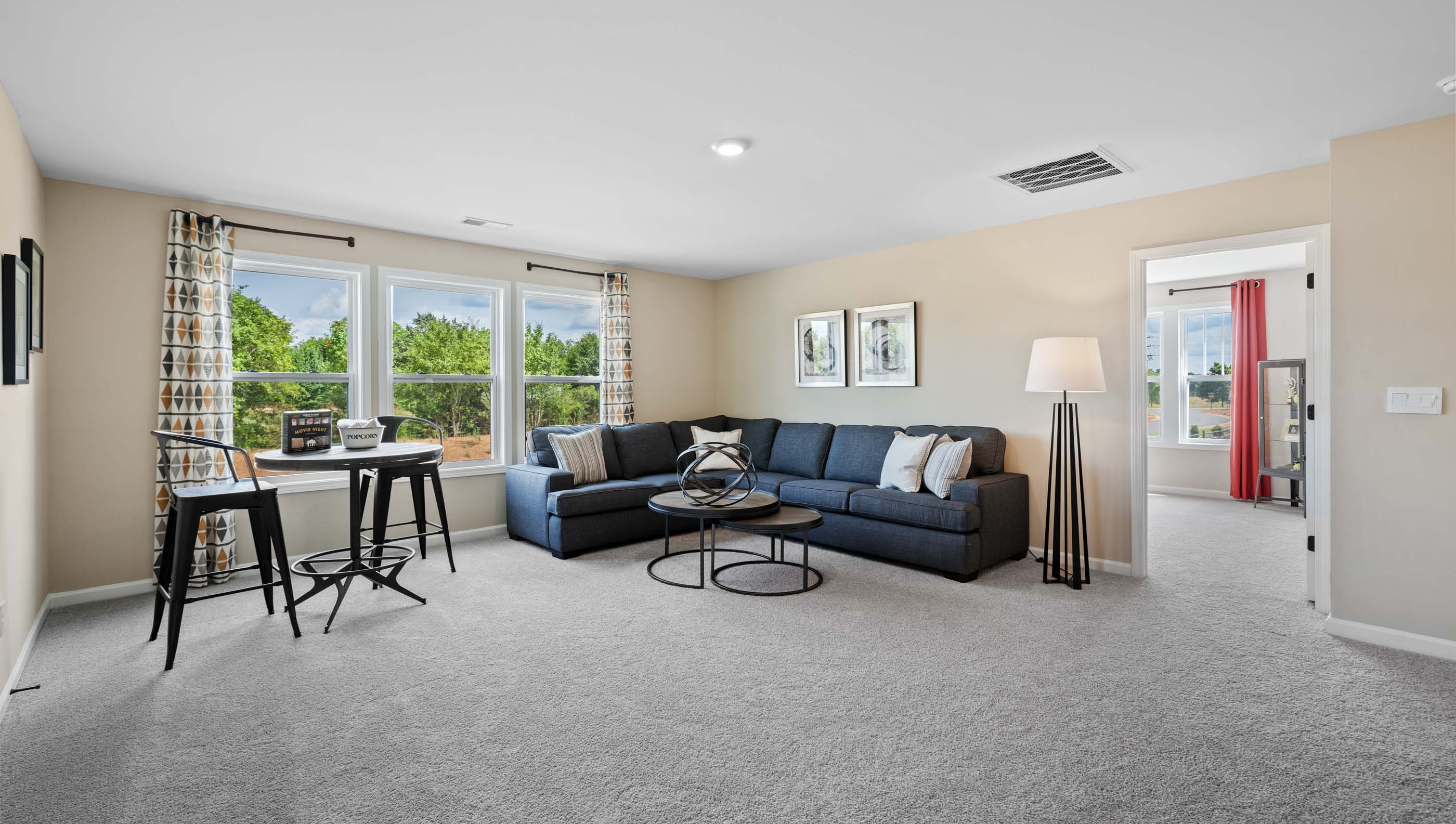Loft area with carpet and window.