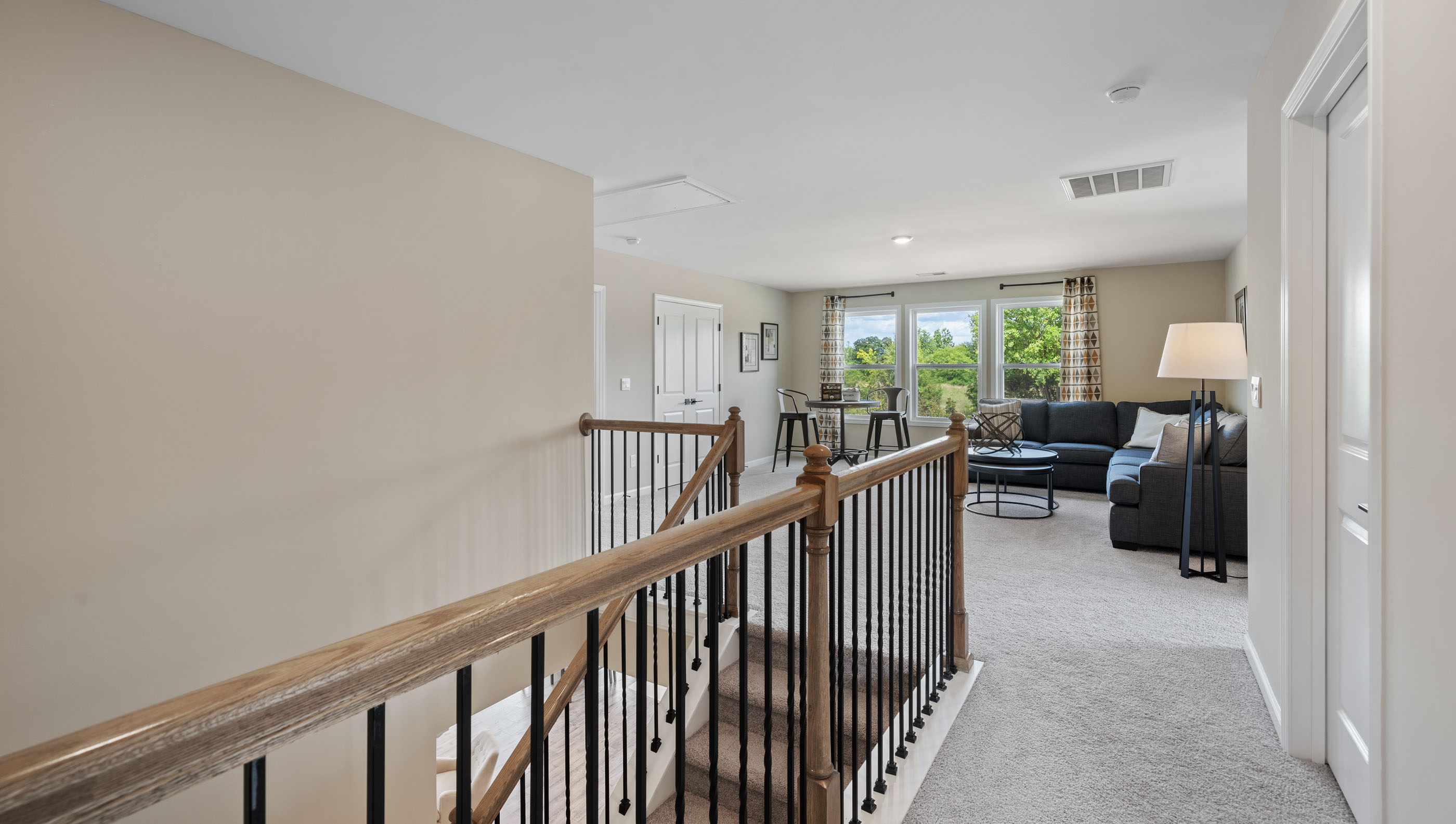 Loft area with carpet and view of bedroom.