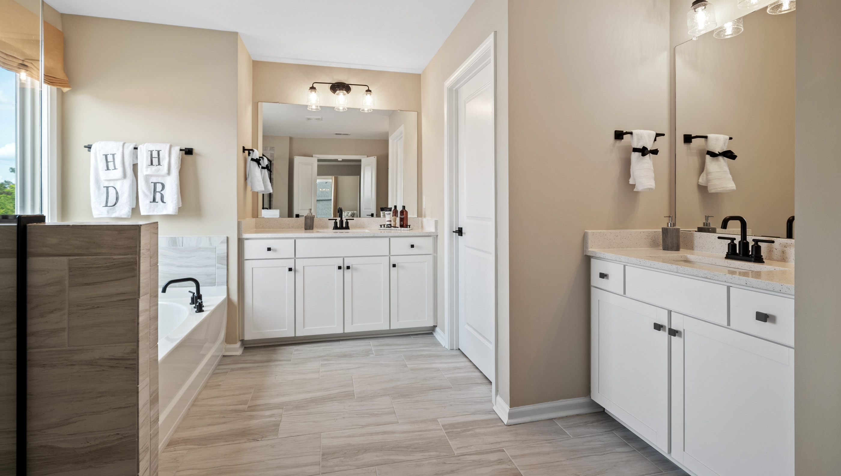 Bathroom with double vanity sink and shower.
