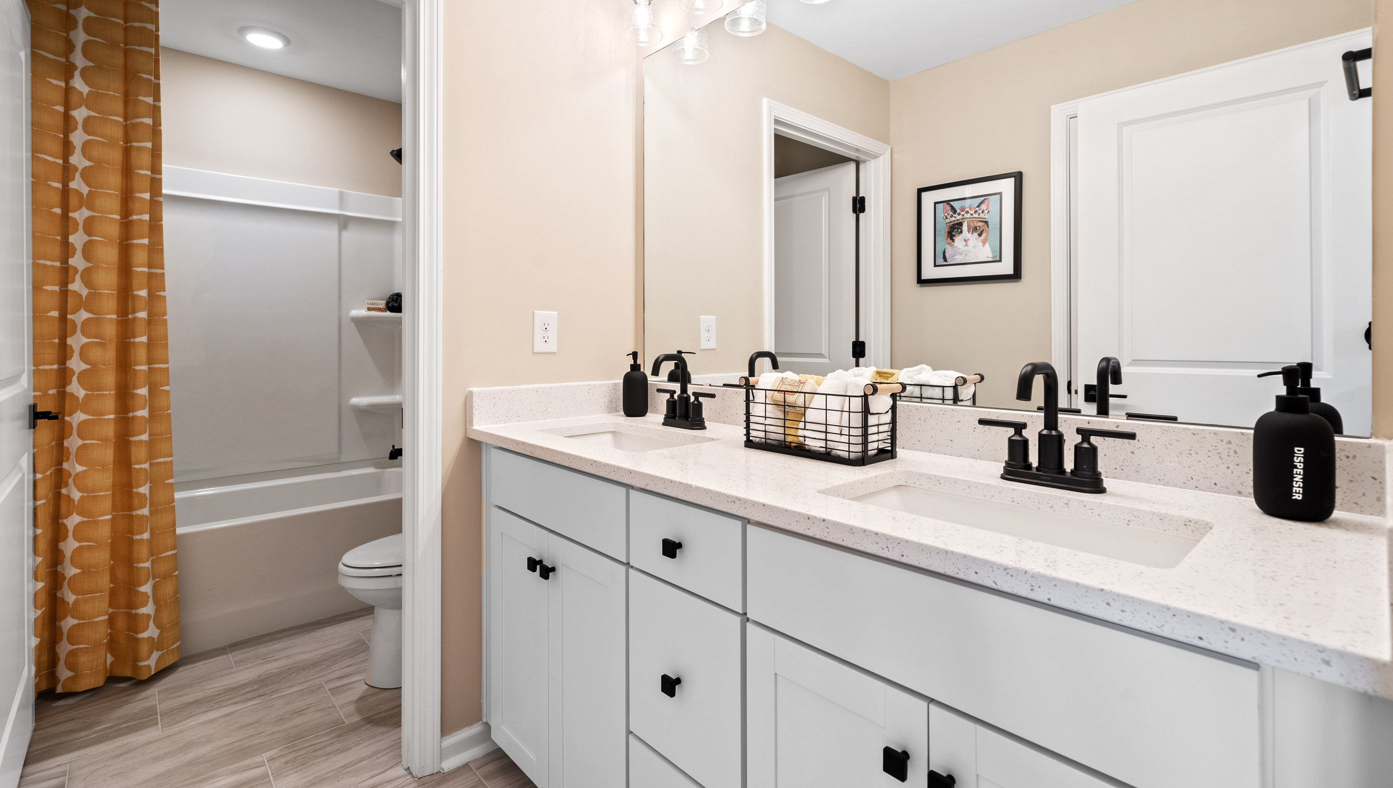 Bathroom with double vanity sink and shower.
