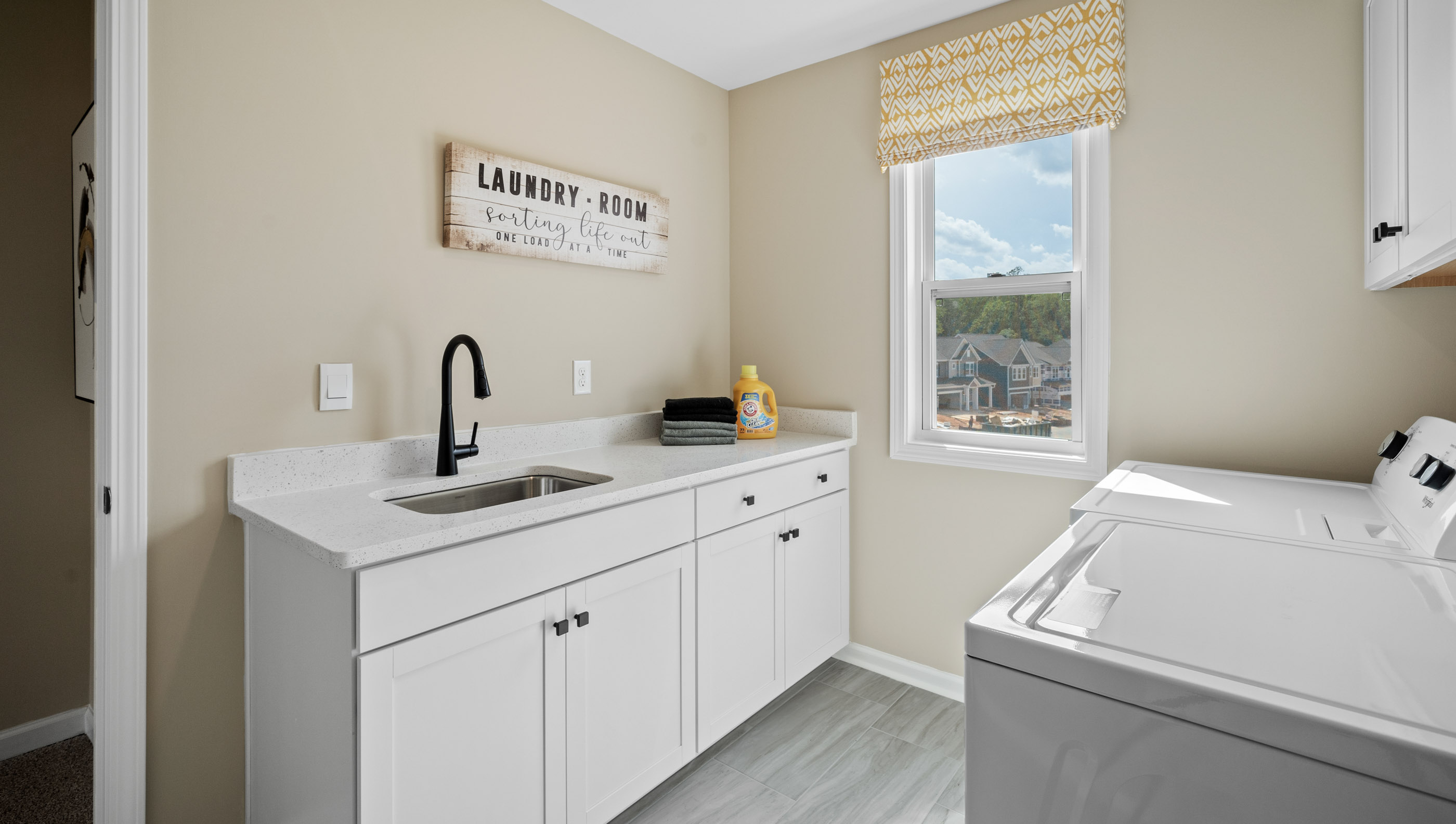 Laundry room with sink and window.