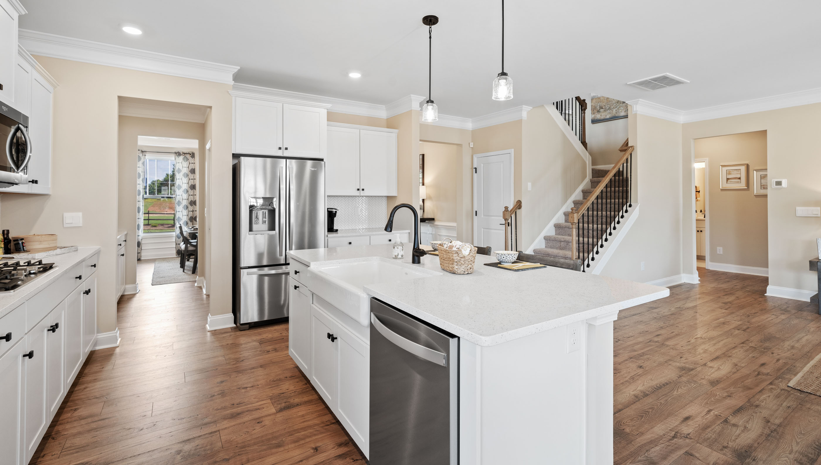 Kitchen and island with white cabinets.