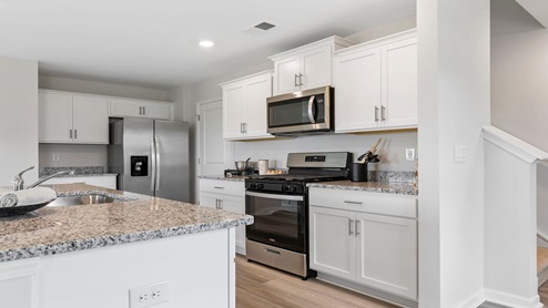 Kitchen and island with granite counter tops.