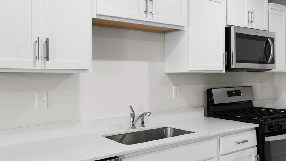 Kitchen with quartz countertops and stainless steel appliances.