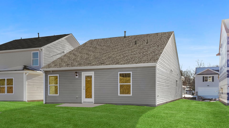 Back exterior of home with large backyard.