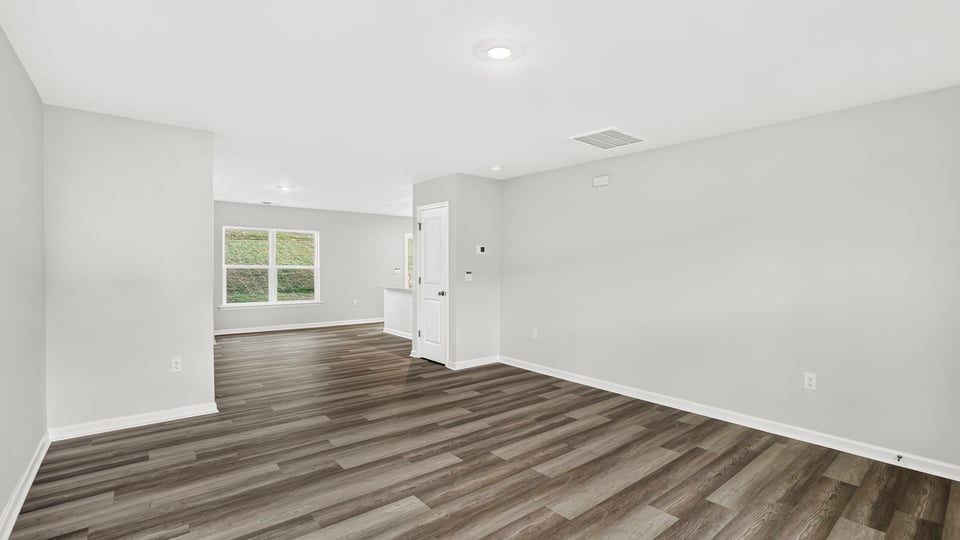 Large living room with windows.