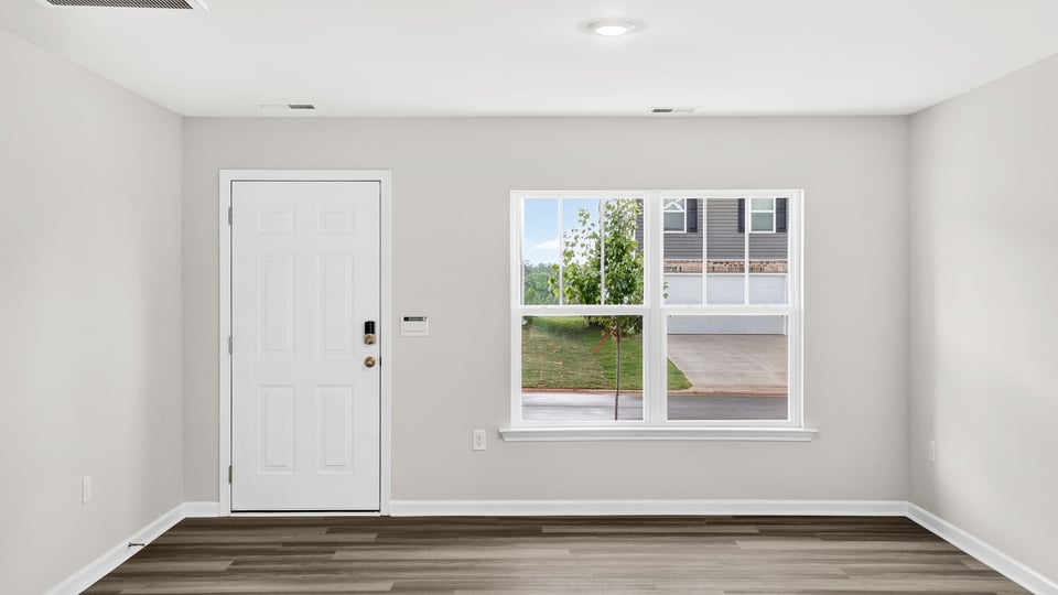 Large living room with windows.