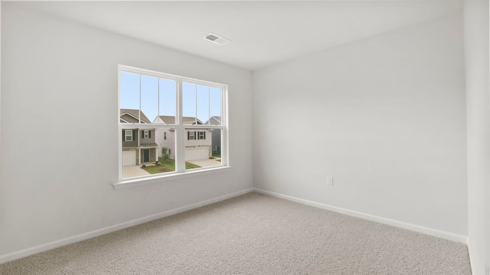 Bedroom with carpet and window.