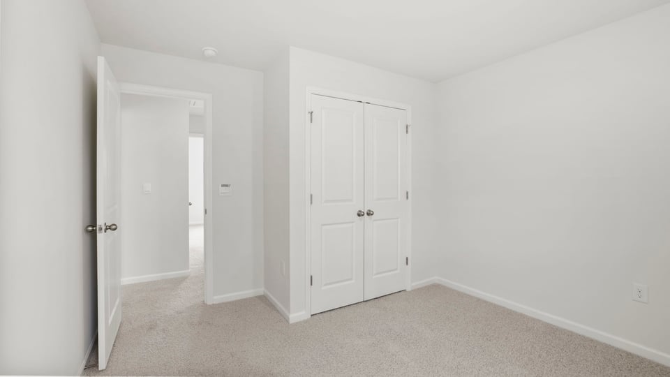 Bedroom with carpet and window.
