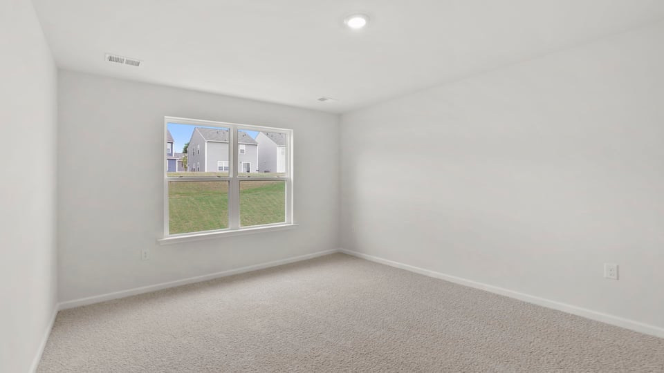 Bedroom with carpet and window.