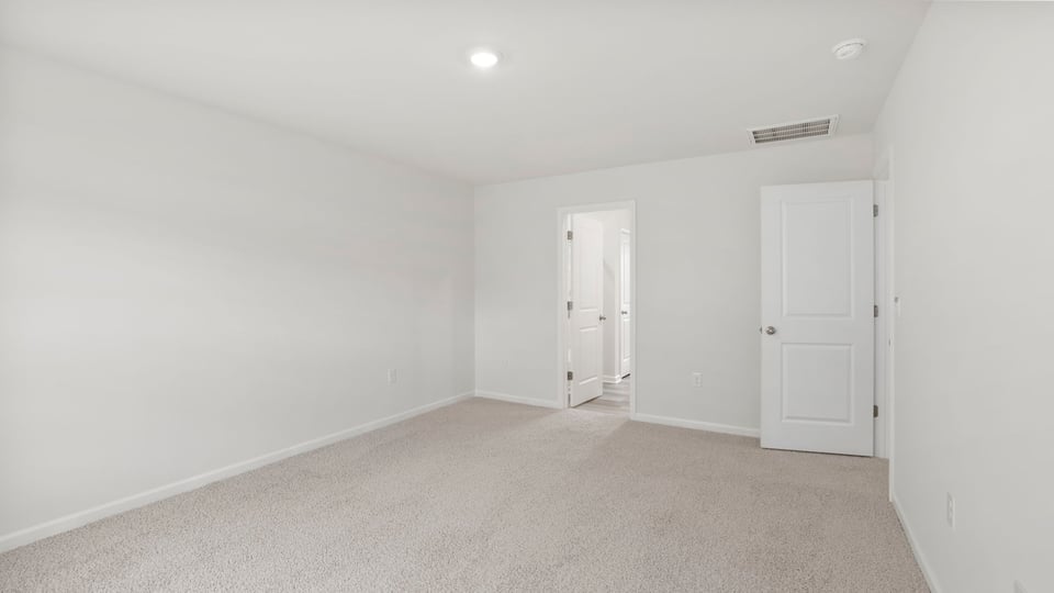 Bedroom with carpet and window.
