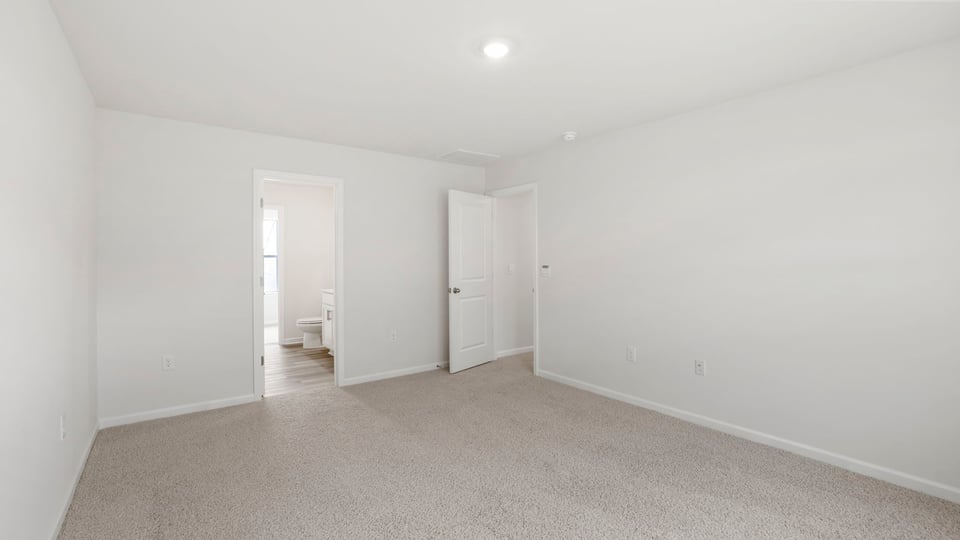 Bedroom with carpet and window.