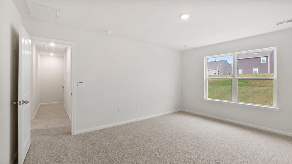 Bedroom with carpet and window.