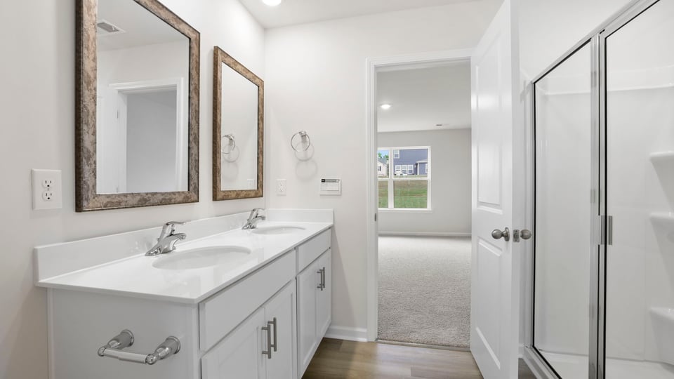 Bathroom with vanity and walk in shower.
