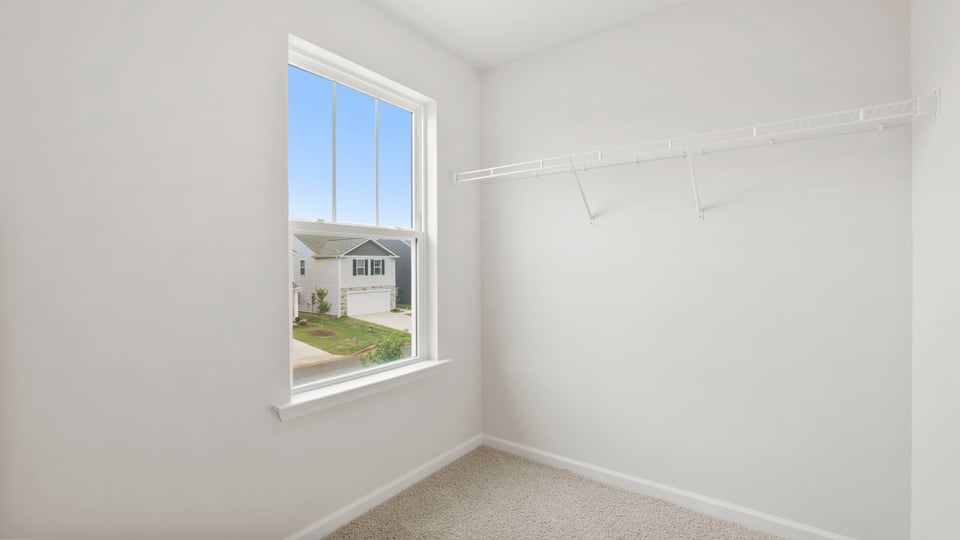 Walk in closet with window.