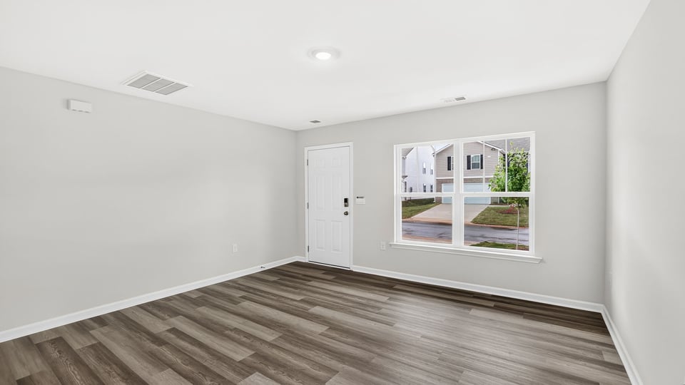 Large living room with windows.